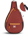 Flat front view of Sherpani sling backpack for women, the Esprit in Cider. Esprit features include front zipper pocket, side zipper pocket, inside mesh pocket, RFID blocking, detachable key chain and an adjustable sling strap. The Cider color is two-toned in burgundy and dark brown with yellow accents.