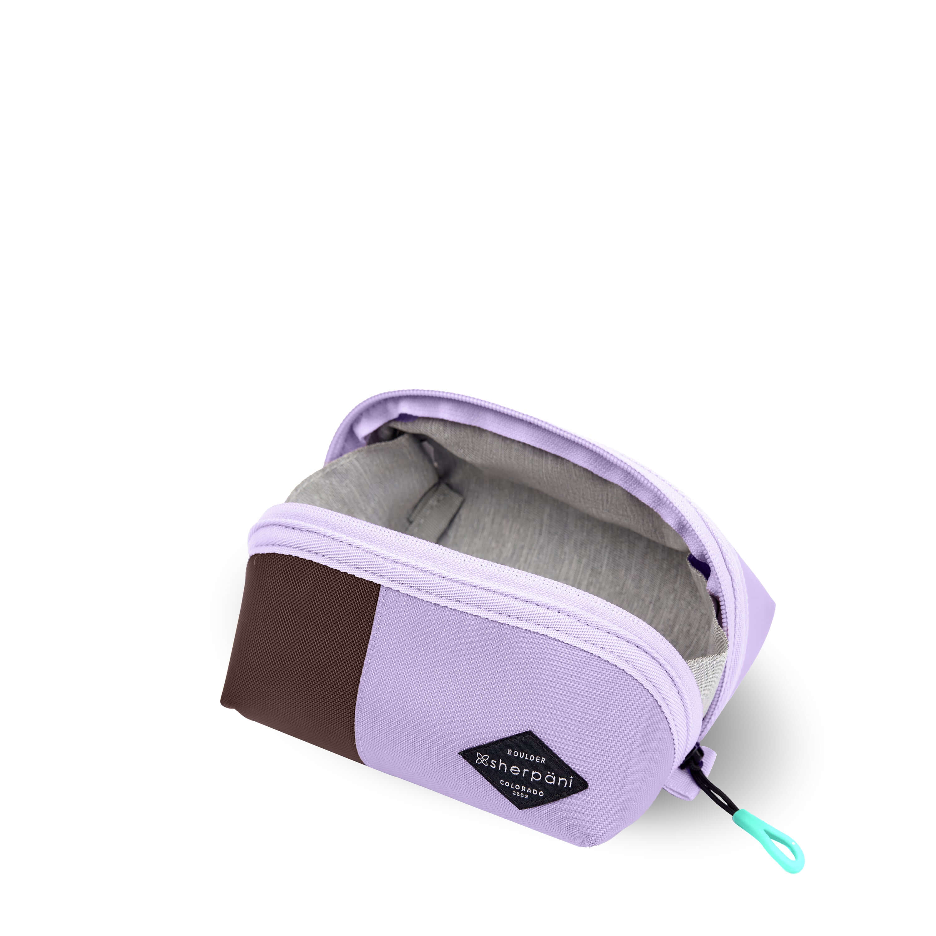 Top view of Sherpani travel accessory the Harmony in Lavender. The pouch is unzipped to reveal a light gray interior.