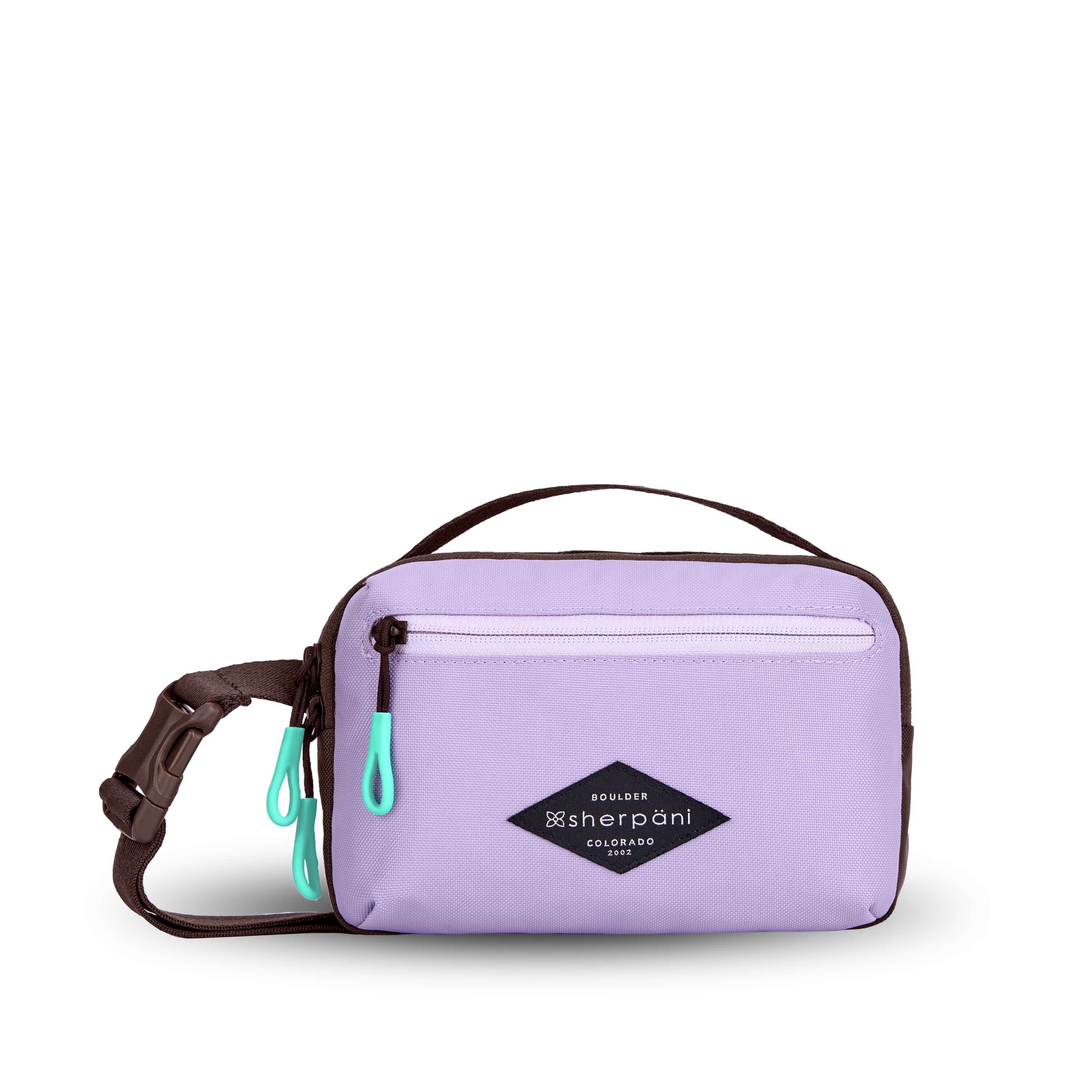 Flat front view of Sherpani’s fanny pack, the Hyk in Lavender. The bag is two-toned, the front half is lavender and the back half is brown. There is an external zipper pocket on the front of the bag. Easy-pull zippers are accented in aqua. The fanny pack features an adjustable strap with a buckle.