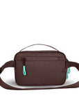 Back view of Sherpani's fanny pack, the Hyk in Lavender. The back of the bag is brown. Easy-pull zippers are accented in aqua. The fanny pack features an adjustable strap with a buckle.