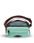Top view of Sherpani's fanny pack, the Hyk in Seagreen. The main zipper compartment is open to reveal a light gray interior and an internal zipper pocket.
