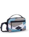 Angled front view of Sherpani’s fanny pack, the Hyk in Summe Camo. The bag is two-toned, the front half is a camouflage pattern of light blue, white and gray, and the back half is black. There is an external zipper pocket on the front of the bag. Easy-pull zippers are accented in black. The fanny pack features an adjustable strap with a buckle.