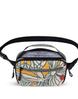 Top view of Sherpani's waist pack, the Hyk in Fiori. The main bag compartment is open to reveal a light gray interior and inside zipper pocket.