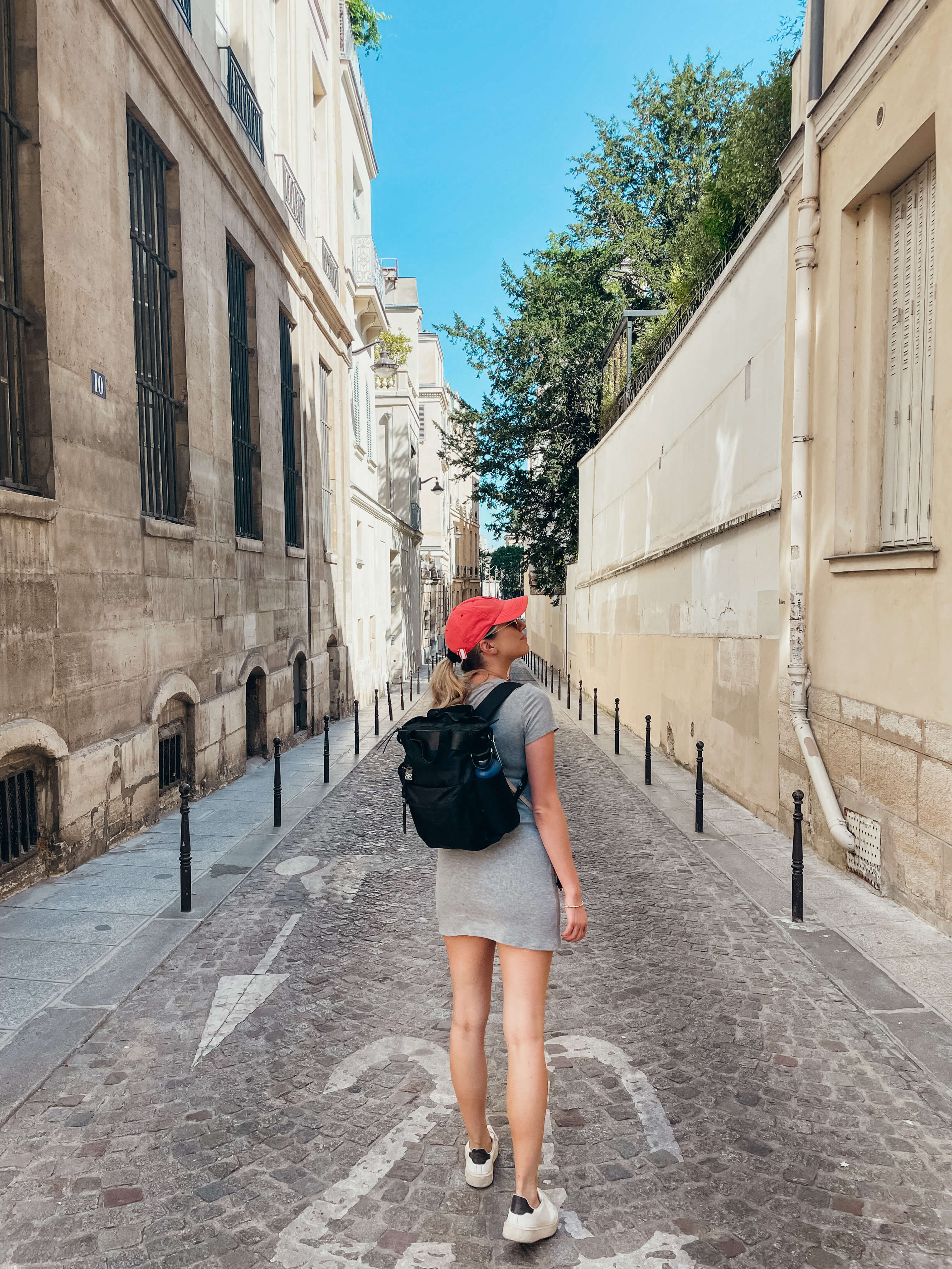 A woman traveling in France with the Sherpani Soleil convertible anti-theft travel backpack