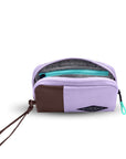 Top view of Sherpani travel accessory the Jolie in Lavender, in medium size. The pouch is unzipped to reveal a light gray interior and internal zipper pocket.