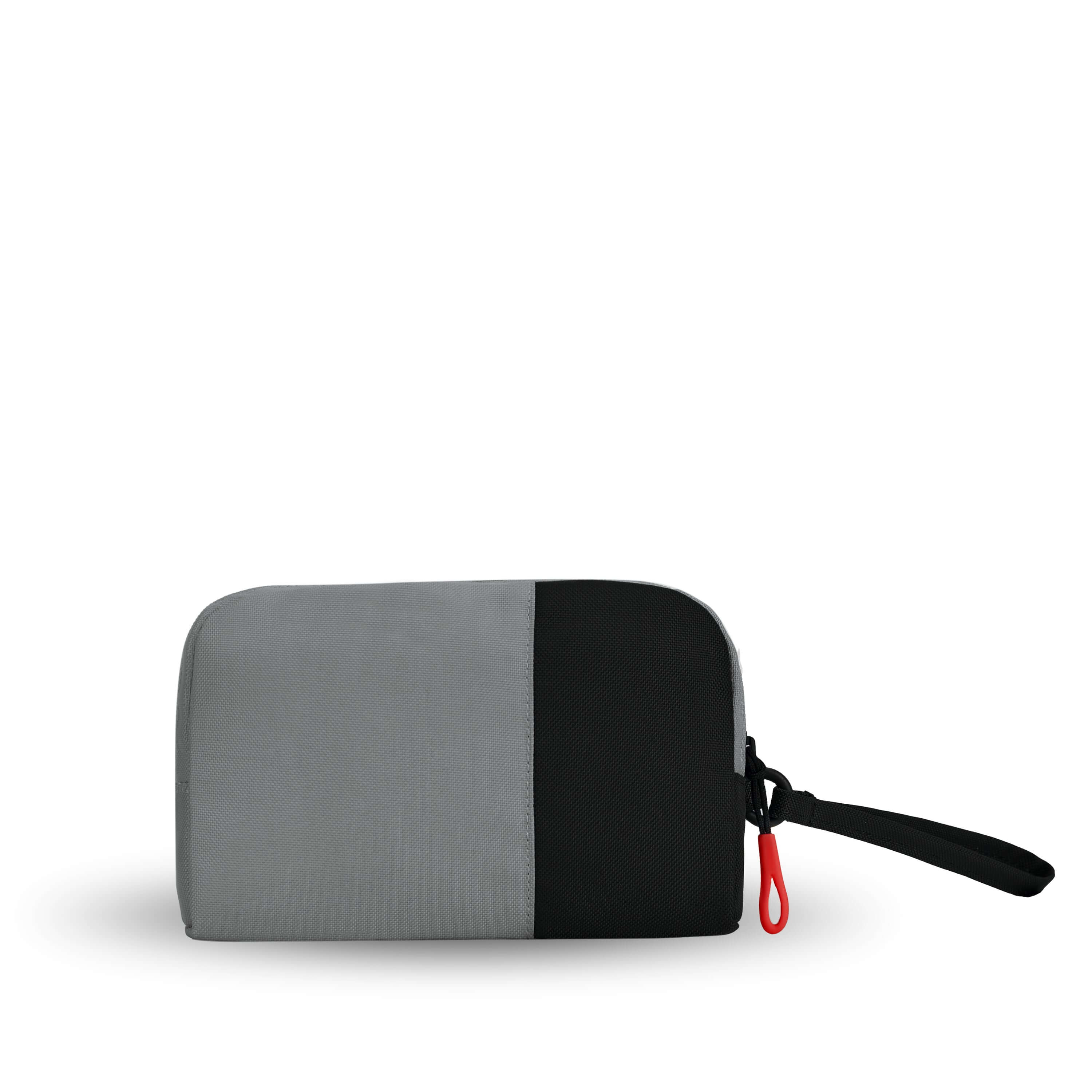 Back view of Sherpani travel accessory, the Jolie in Stone, in small size. The pouch is two-toned in gray and black. It features a black wristlet strap and an easy-pull zipper accented in red.