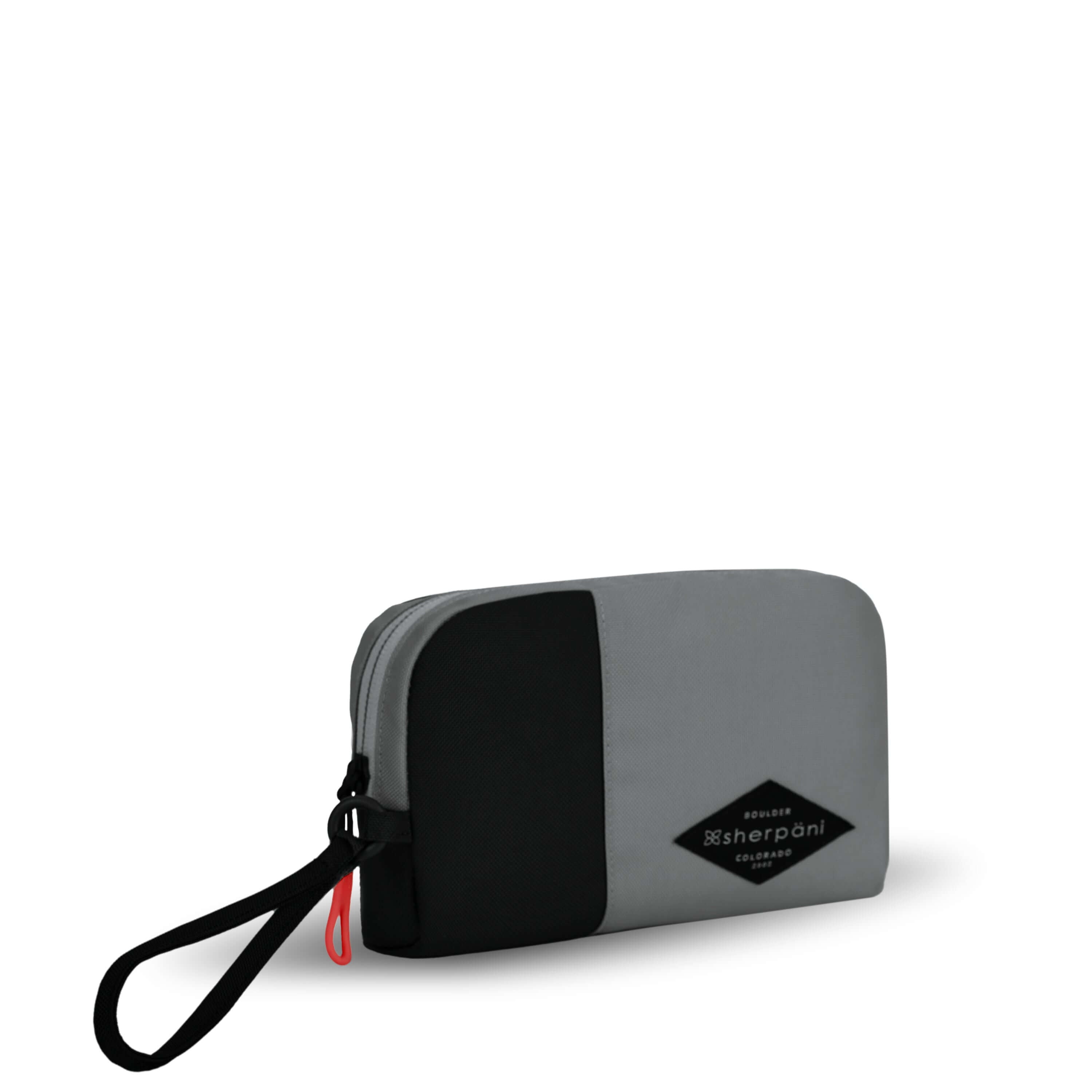 Angled front view of Sherpani travel accessory, the Jolie in Stone, in medium size. The pouch is two-toned in gray and black. It features a black wristlet strap and an easy-pull zipper accented in red.