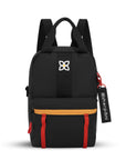 Flat front view of Sherpani mini backpack the Logan in Chromatic. The bag is black with blue, yellow and red accents. The Logan has fixed tote handles and adjustable backpack straps.