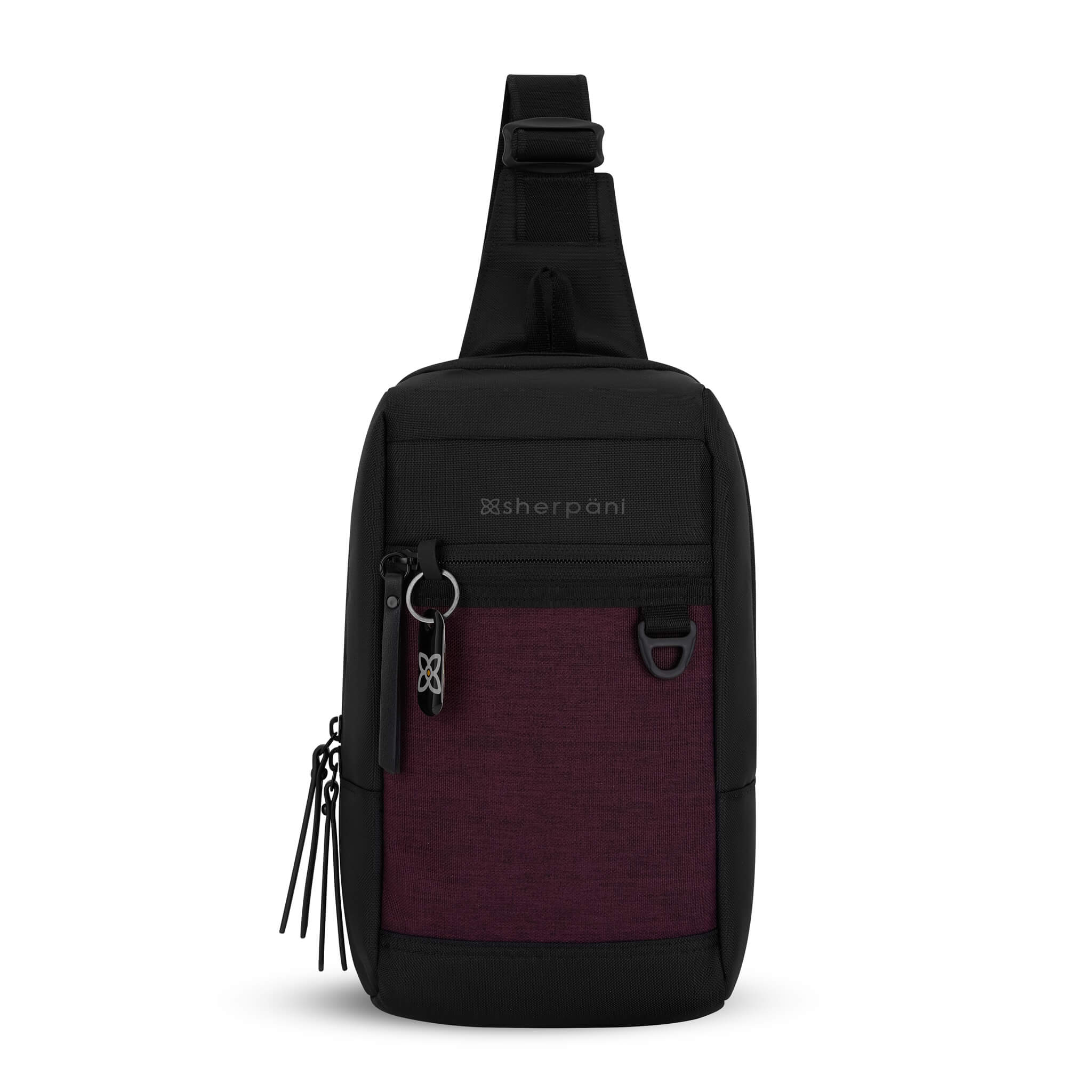Flat front view of Sherpani mini sling bag, the Metro in Merlot. This Anti-Theft sling includes security features for safe travels and an adjustable crossbody strap that can convert the Metro for the left-handed user. 