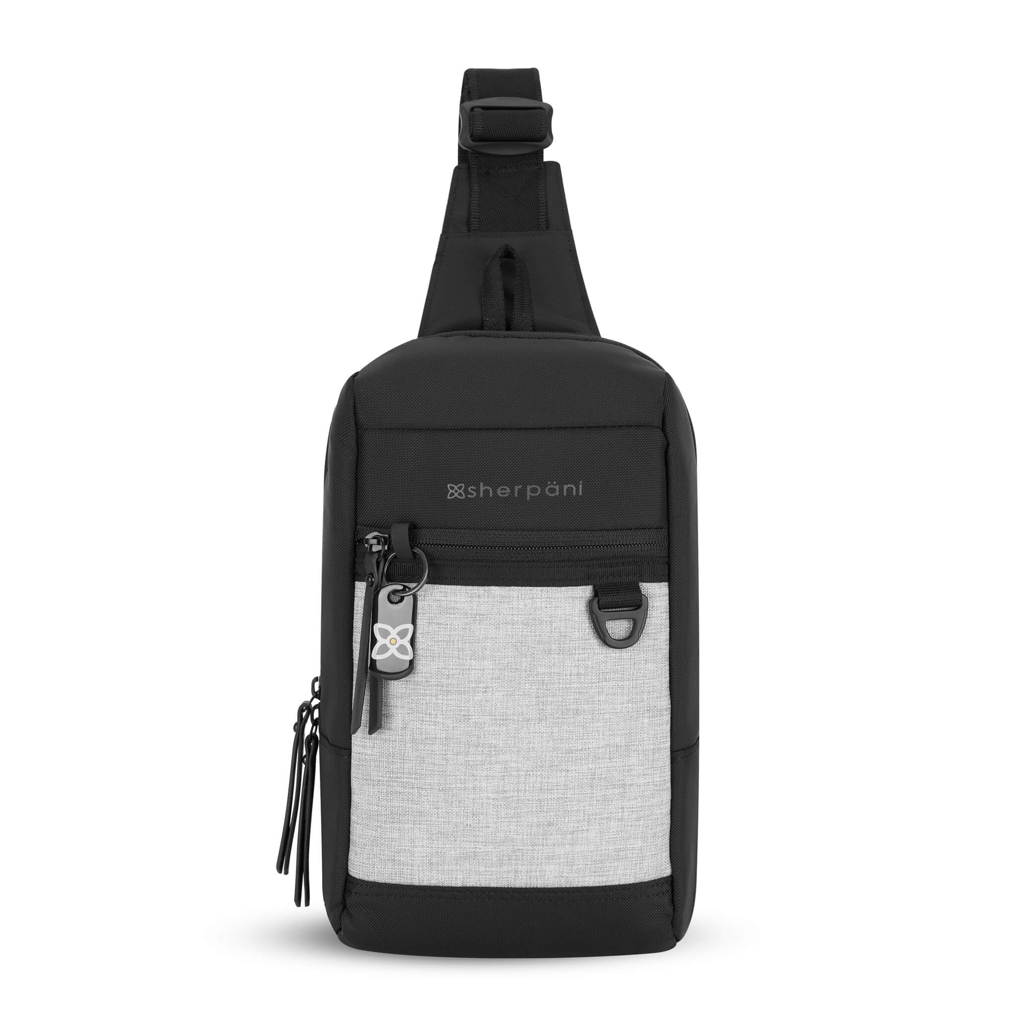 Flat front view of Sherpani mini sling bag, the Metro in Sterling. This Anti-Theft sling includes security features for safe travels and an adjustable crossbody strap that can convert the Metro for left-handed users.  