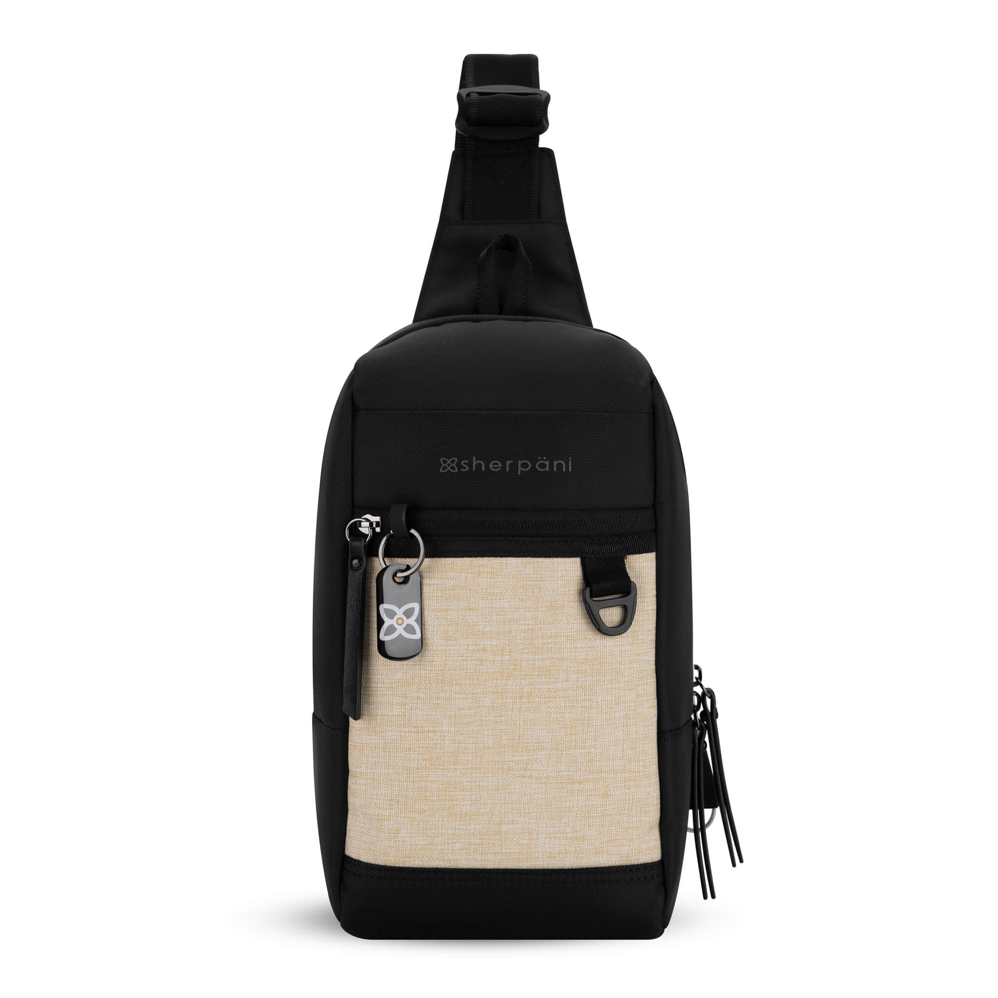 Flat front view of Sherpani mini sling bag, the Metro in Straw. This Anti-Theft sling includes security features for safe travels and an adjustable crossbody strap that can convert the Metro for left-handed users.  