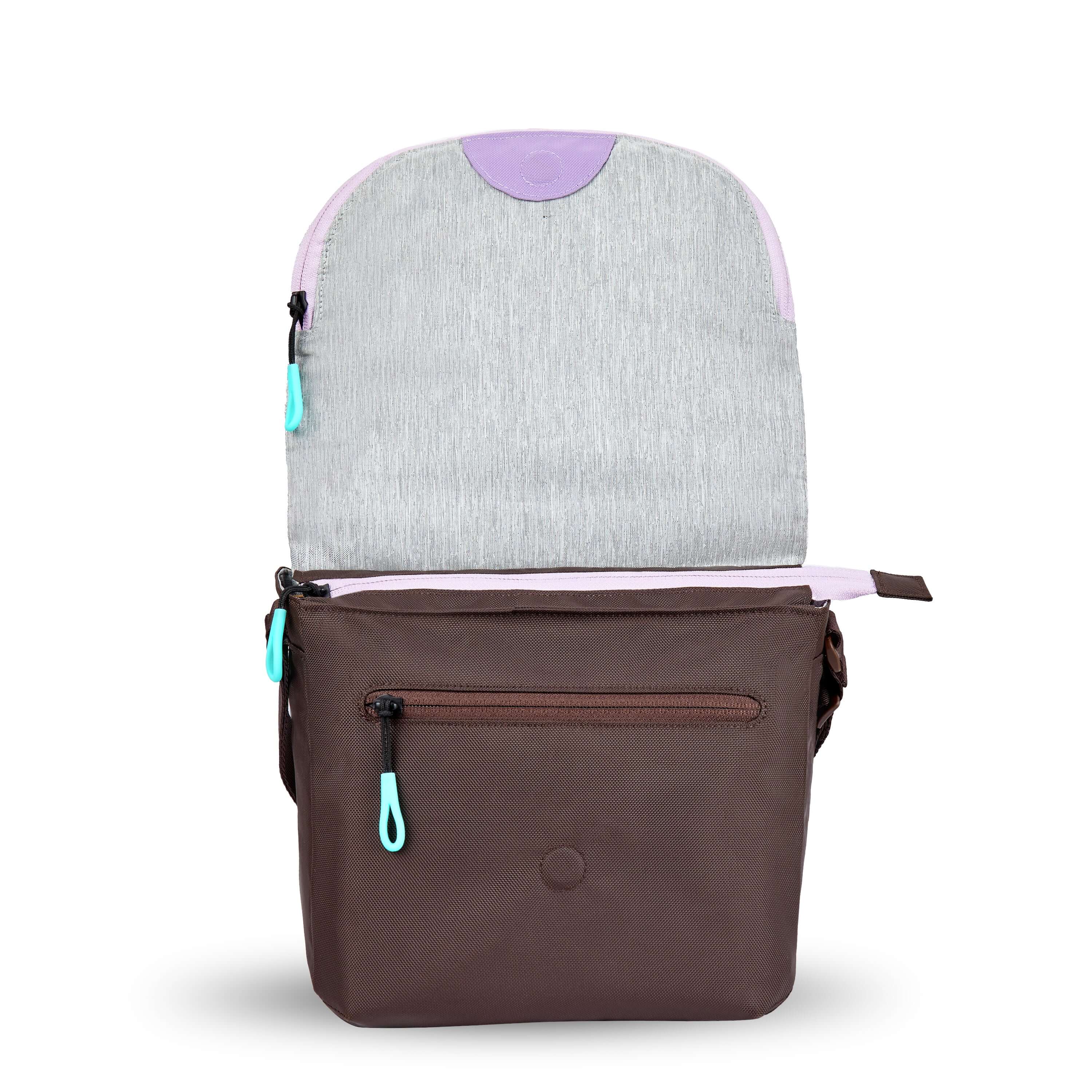 Front view of Sherpani crossbody, the Milli in Lavender. The layover flap is standing tall to reveal an external zipper pocket and a small magnet that holds the flap down.