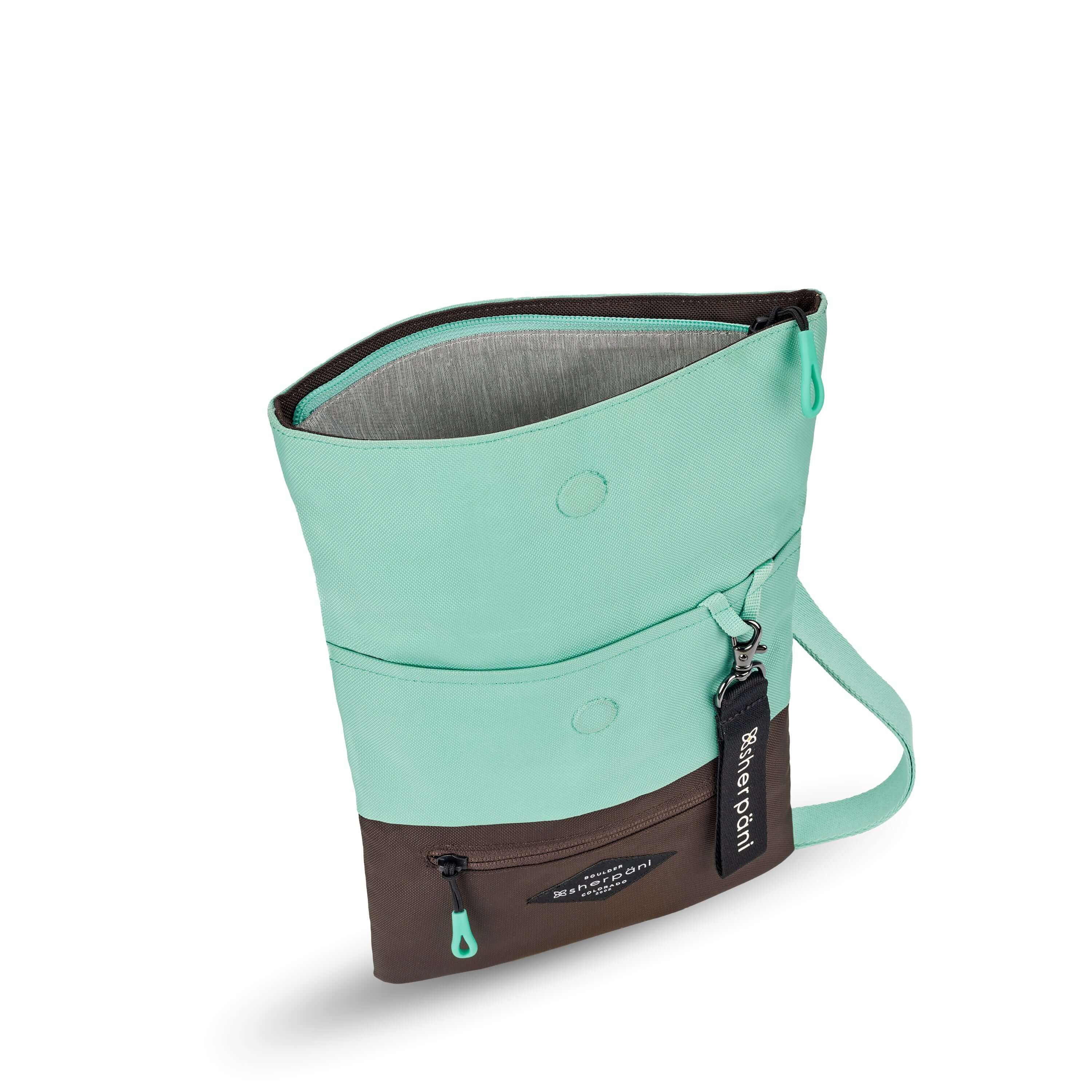 Top view of Sherpani crossbody, the Pica in Seagreen. The bag is unfolded to stand tall and the main zipper compartment is open to reveal a light gray interior. 