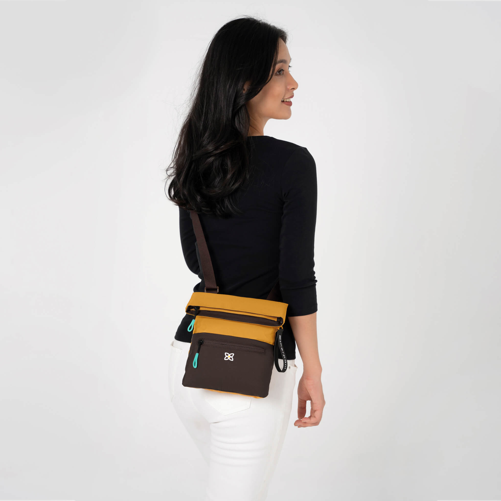 A model wearing Sherpani RFID purse, the Pica in Sundial. 