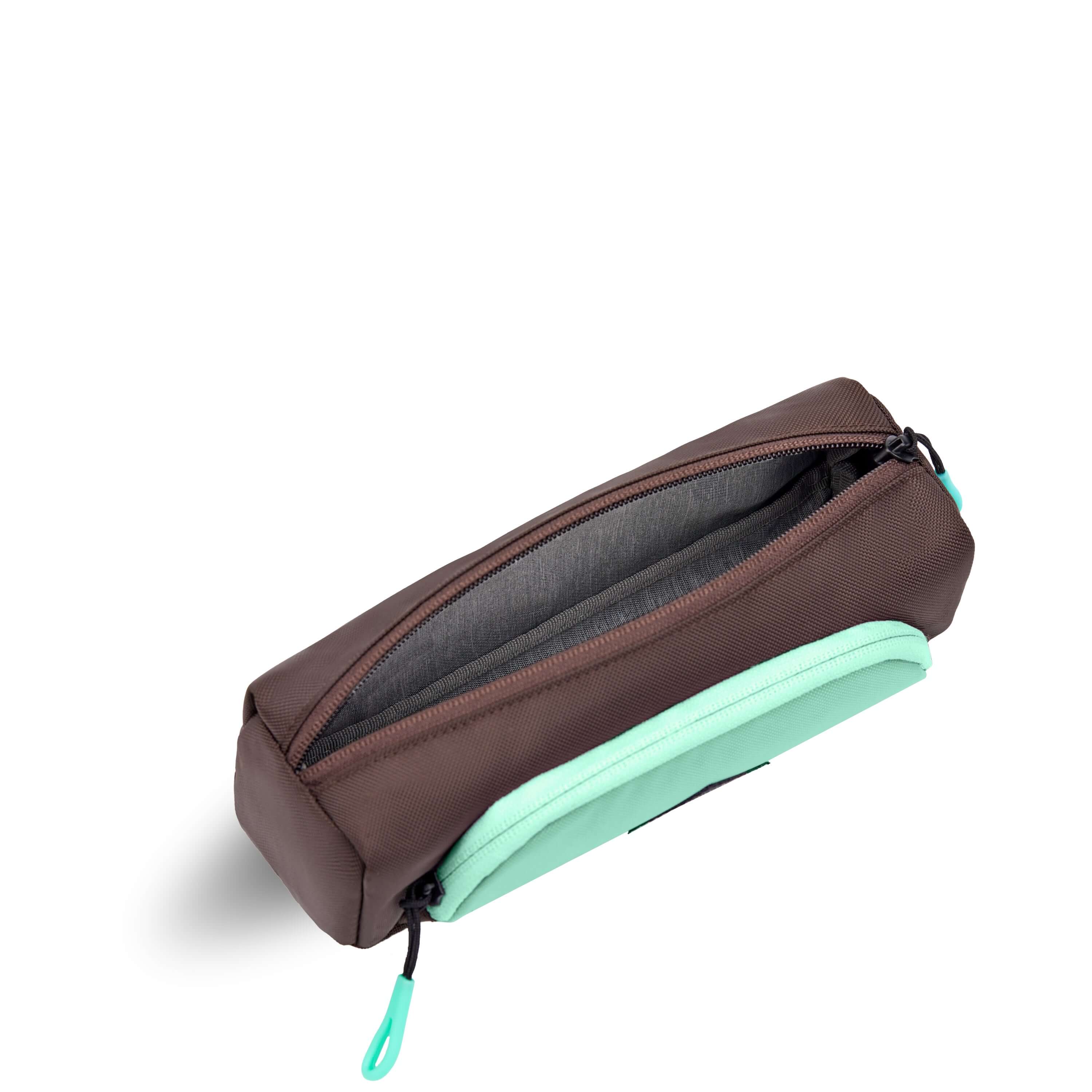 Top view of Sherpani travel accessory, the Poet in Seagreen. The pouch is unzipped to reveal a light gray interior.