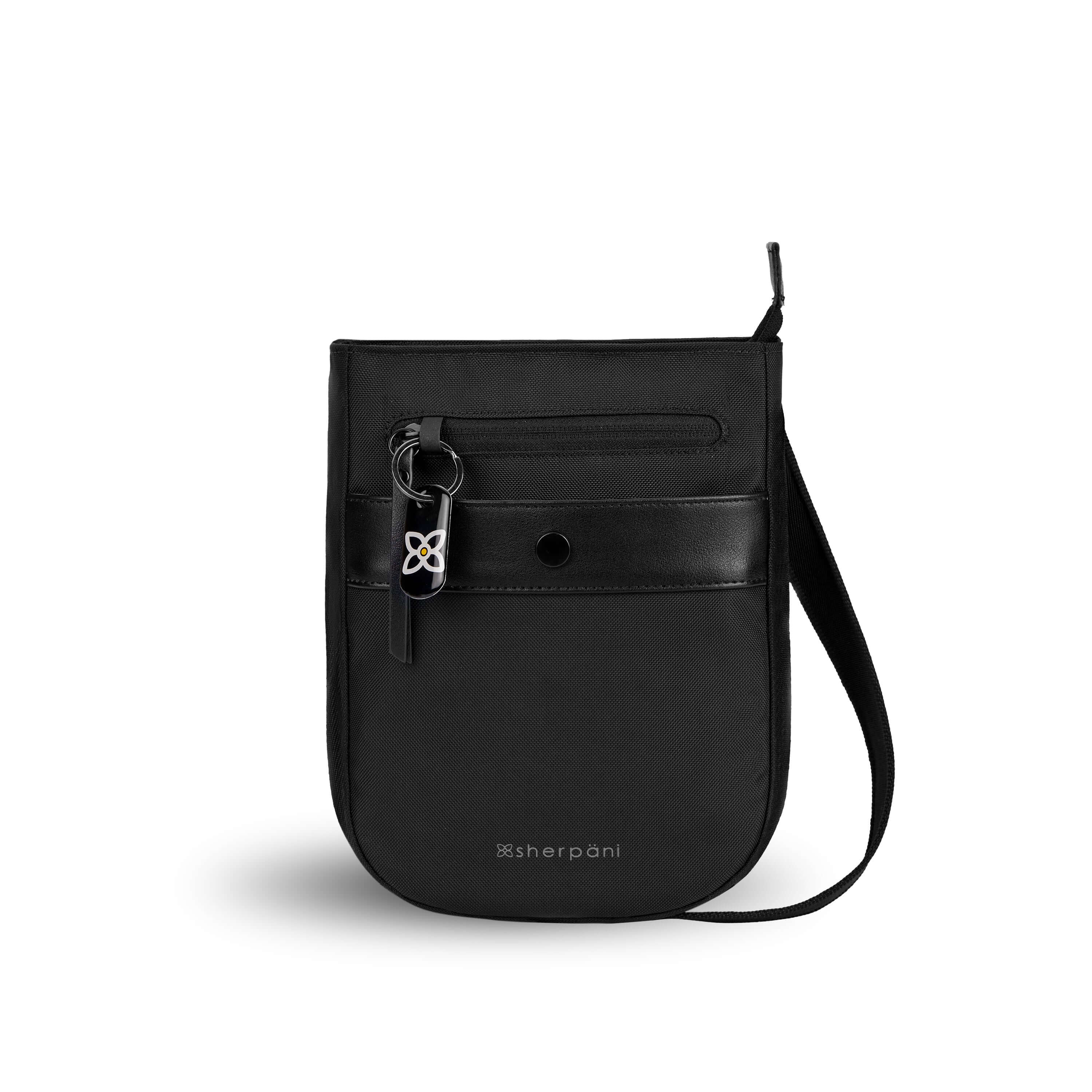 Flat front view of Sherpani’s Anti-Theft bag, the Prima AT in Carbon, with vegan leather accents in black. There is an external pouch on the front of the bag that sits below a locking zipper compartment, which has a ReturnMe tag clipped to it. The bag features an adjustable crossbody strap.