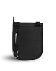 Back view of Sherpani's Anti-Theft bag, the Prima AT in Carbon, with vegan leather accents in black. There is an external pouch on the back of the bag, and a chair loop lock clipped to the left side that is secured in place with an elastic tab.