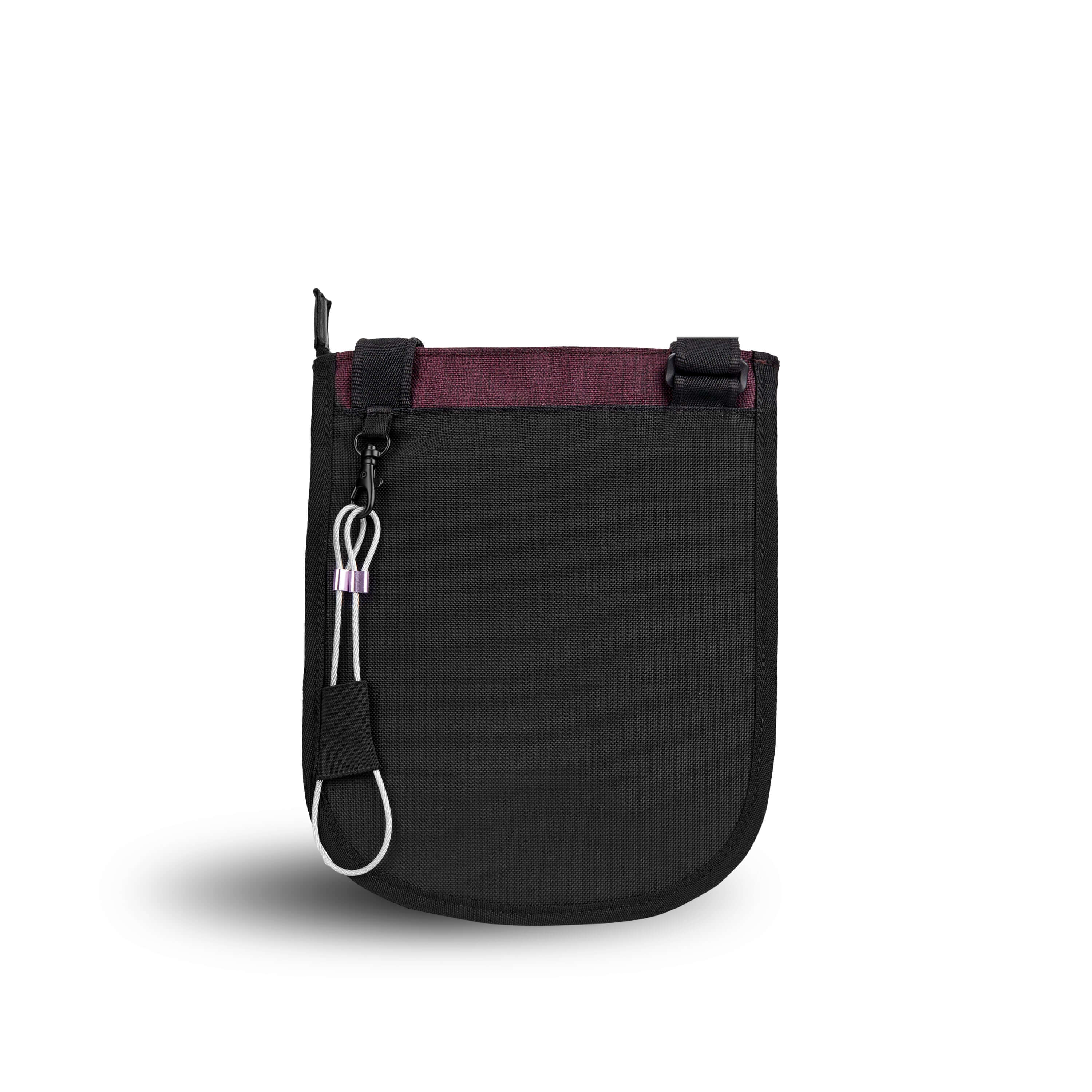 Back view of Sherpani&#39;s Anti-Theft bag, the Prima AT in Merlot, with vegan leather accents in black. There is an external pouch on the back of the bag, and a chair loop lock clipped to the left side that is secured in place with an elastic tab.