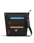 Flat front view of Sherpani crossbody travel bag, the Sadie in Chromatic. Sadie features include two front zipper pockets, a discrete side pocket, detachable keychain, adjustable crossbody strap, back slip pocket and RFID blocking technology. The Chromatic color is mostly black with pops of color in yellow, blue and red.
