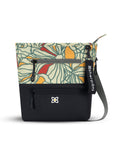 Flat front view of Sherpani crossbody travel bag, the Sadie in Fiori. Sadie features include two front zipper pockets, a discrete side pocket, detachable keychain, adjustable crossbody strap, back slip pocket and RFID blocking technology. The Fiori colorway is two-toned in black and a floral pattern with red accents.