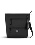 Flat front view of Sherpani crossbody travel bag, the Sadie in Raven. Sadie features include two front zipper pockets, a discrete side pocket, detachable keychain, adjustable crossbody strap, back slip pocket and RFID blocking technology. The Raven color is solid black with Sherpani logo (edelweiss flower) accented in white.