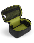 Inside view of Sherpani travel accessory the Savannah. The interior is lime green. There is a zippered mesh compartment on the top of the case. An elastic band runs along the inside of the case creating organizational slots.
