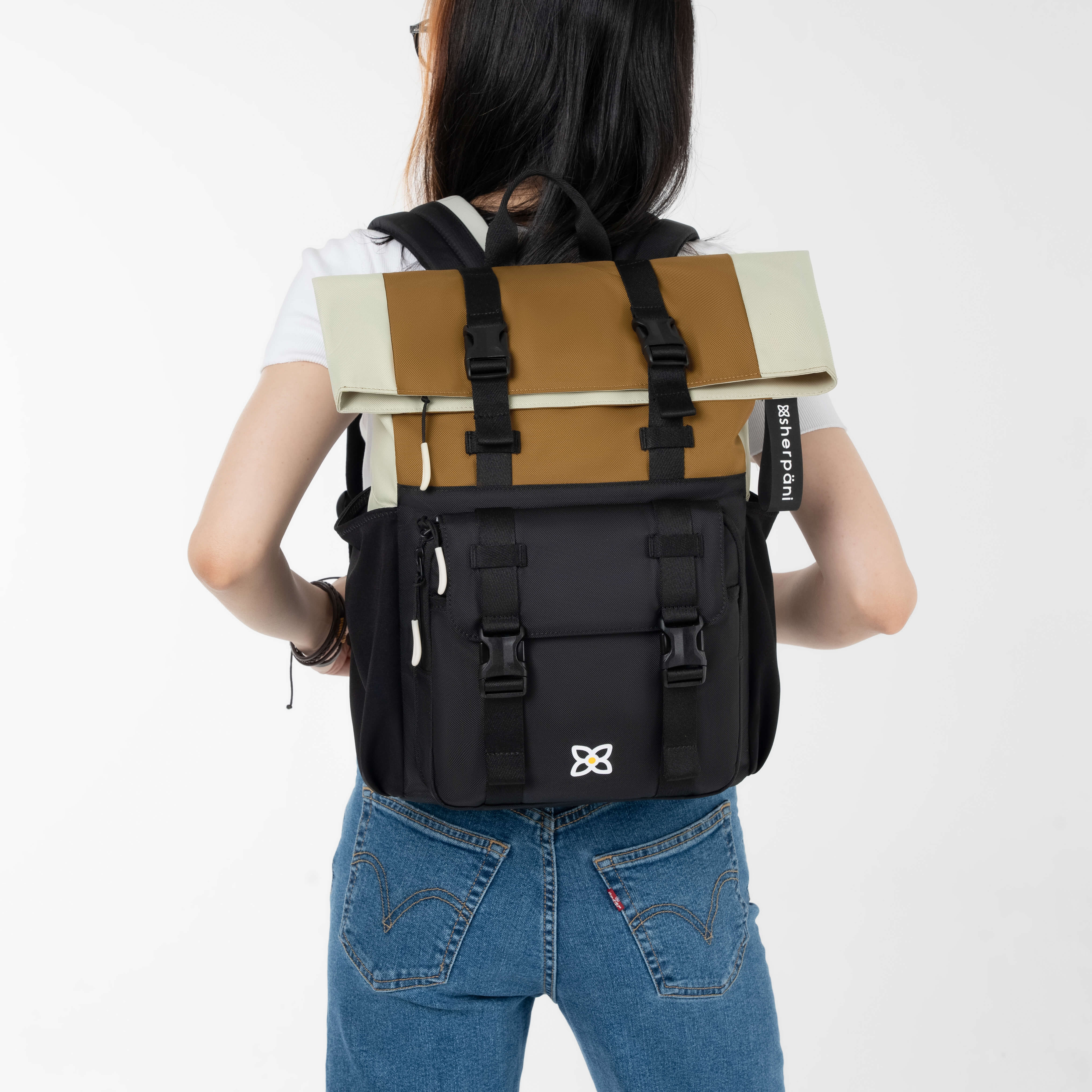 Back view of a model wearing Sherpani women's travel backpack, the Sedona in Elmwood. 