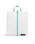 Flat front view of Compass Shoe Bag. The bag is white with zipper and handle accented in aqua.