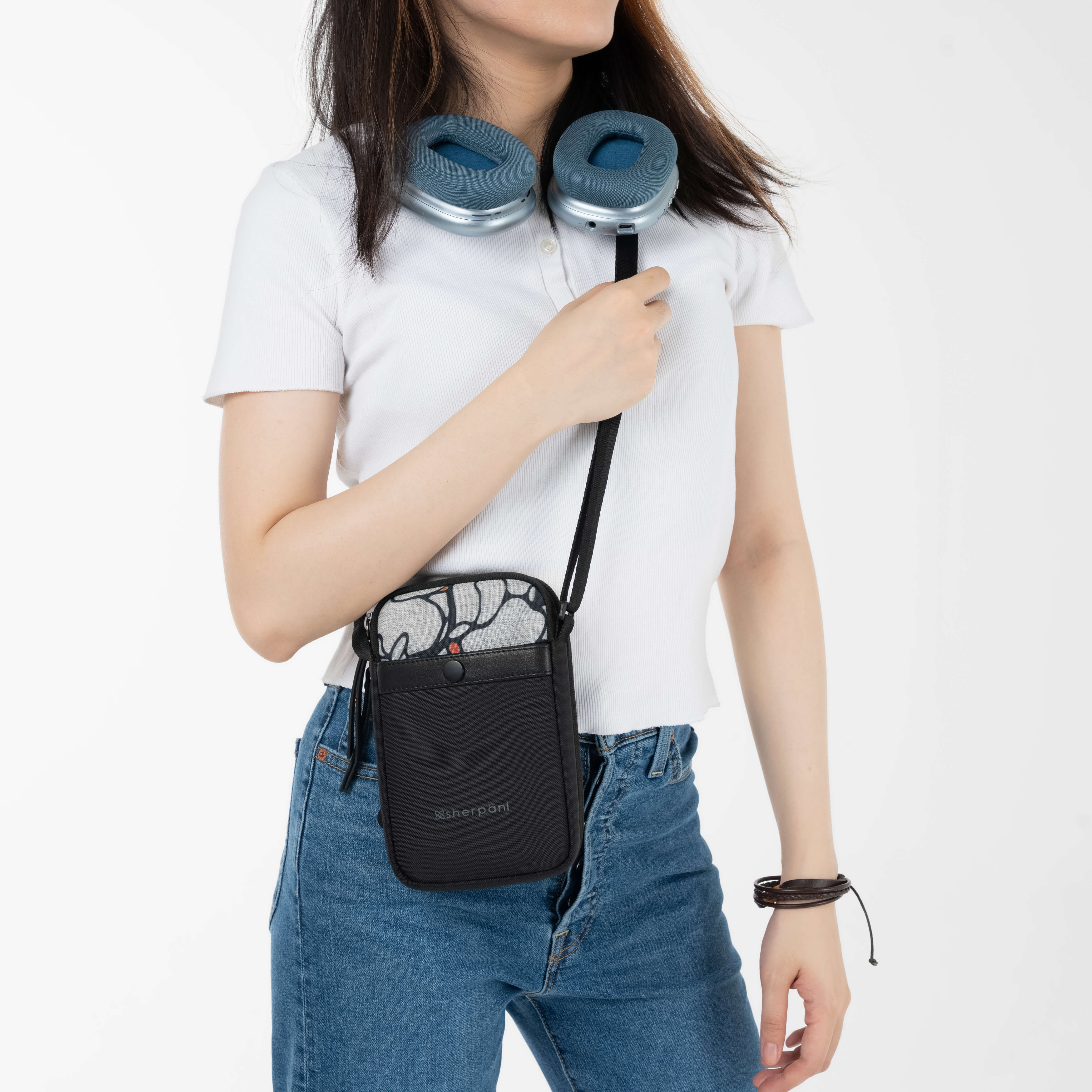 A model wearing Sherpani wallet purse for travel, the Simplicity in Sakura. 