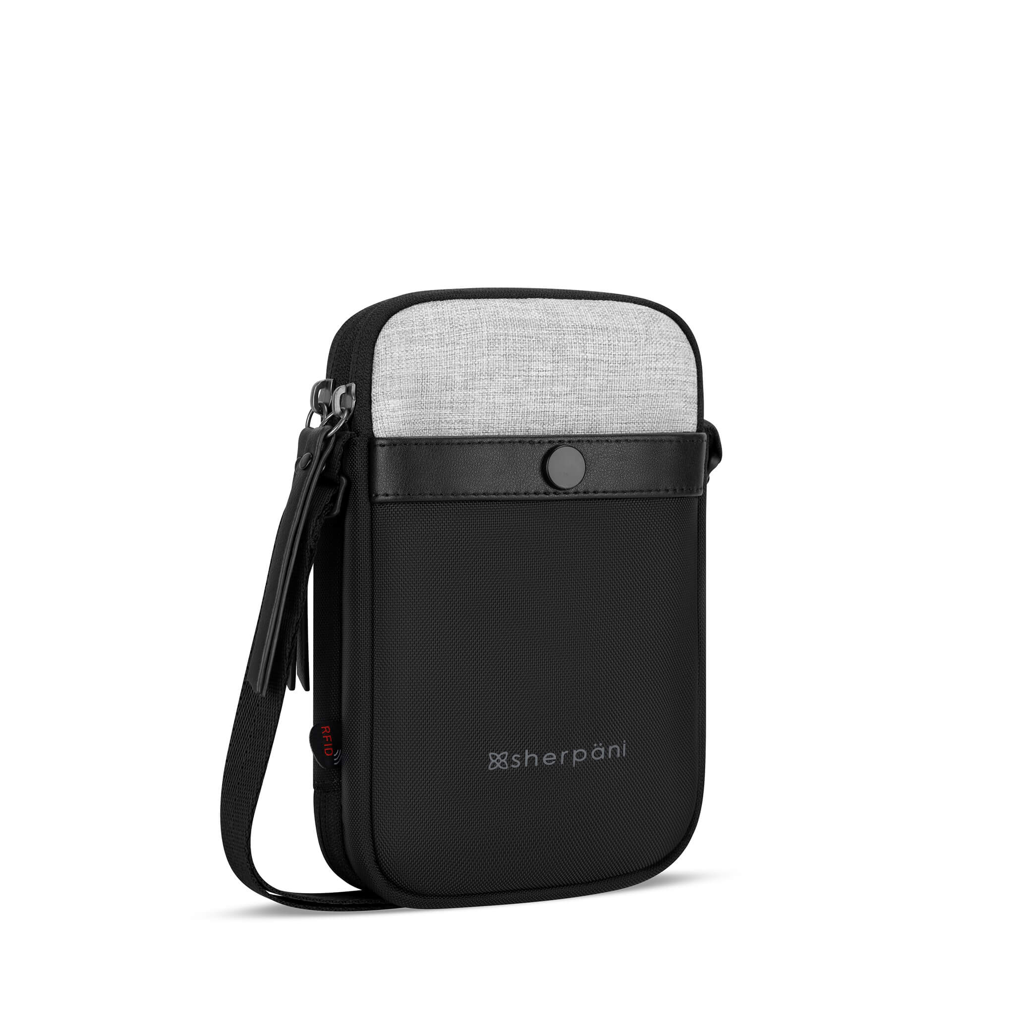 Angled front view of Sherpani crossbody wallet, the Simplicity in Sterling. The simple and minimalist bag includes anti-theft features and an adjustable crossbody strap. 