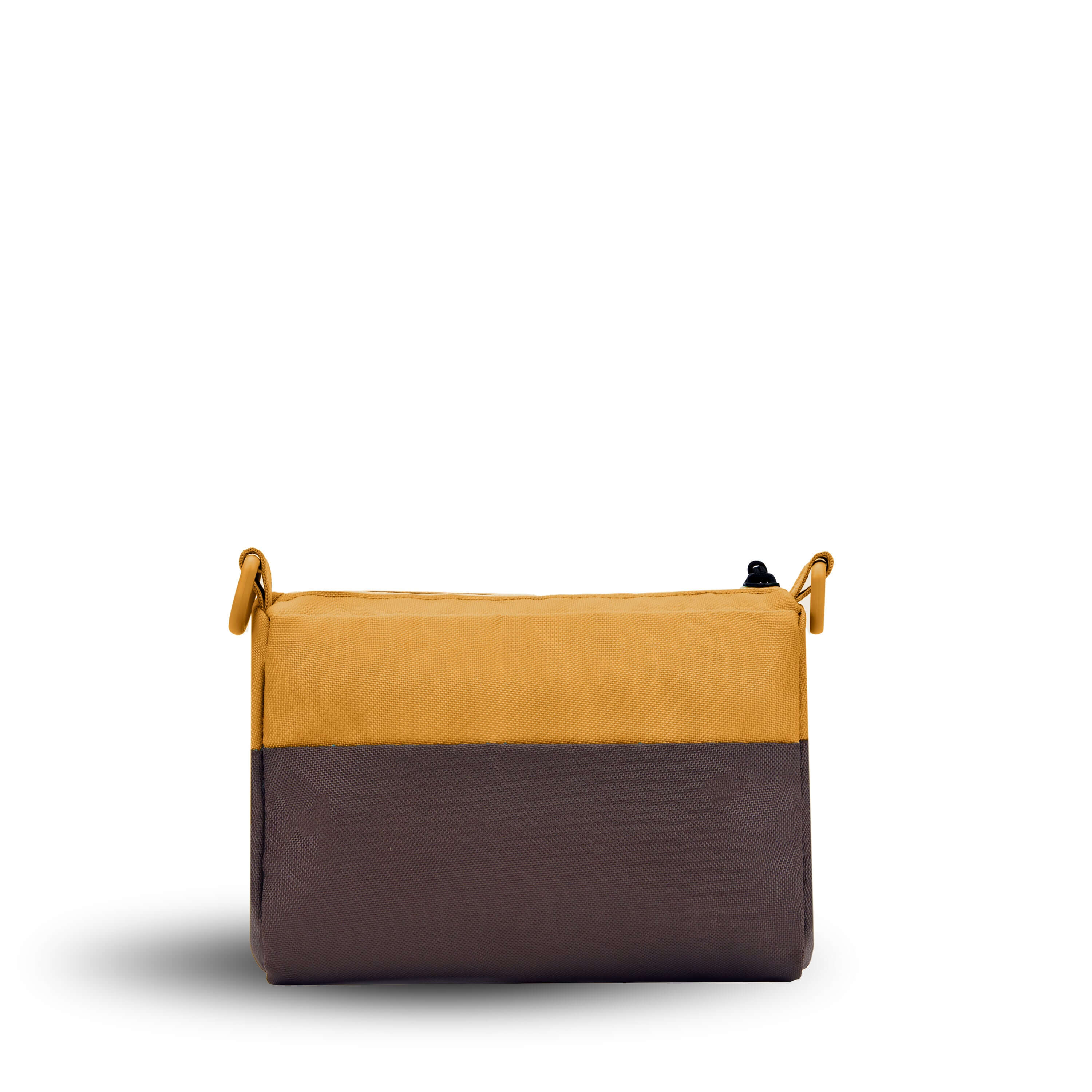 Back view of Sherpani's purse, the Skye in Sundial. It is two-toned, the top half of the bag is burnt yellow and the bottom half of the bag is brown. 