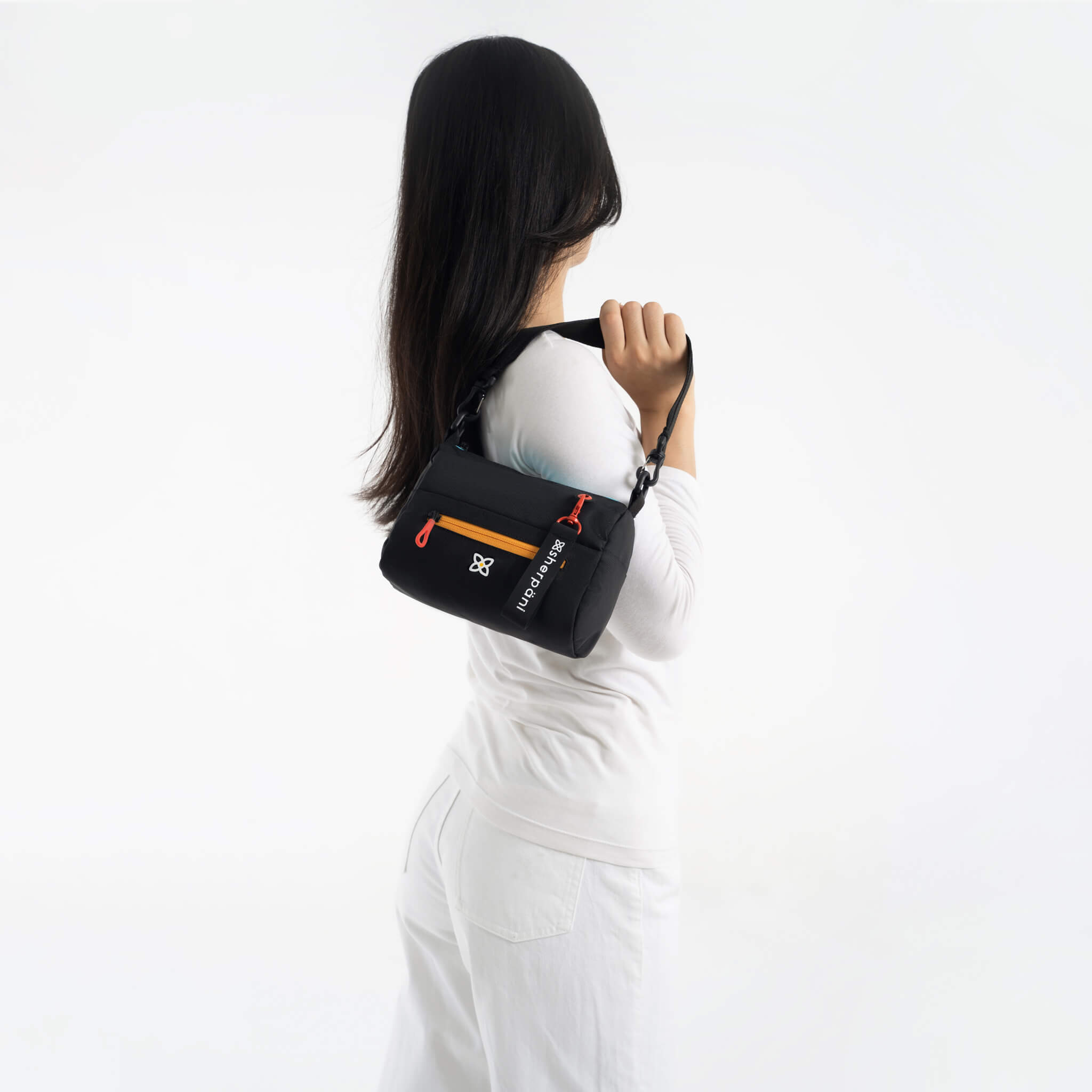 A model showing Sherpani RFID protected purse, the Sky in Chromatic. 