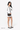 Model turned slightly to the side, wearing  Sherpani purse, the Skye in Chromatic, as a shoulder bag. #color_chromatic