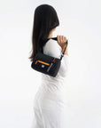A model showing Sherpani RFID protected purse, the Sky in Chromatic.