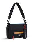 Angled front view of Sherpani mini shoulder bag, the Skye in Chromatic. Skye features include RFID security, detachable keychain, outside zipper pocket, two inside zipper pockets and two removable straps: a short shoulder strap and a longer adjustable crossbody strap. The Chromatic color has a black base and pops of color in blue, yellow and red.