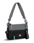 Angled front view of Sherpani mini shoulder bag, the Skye in Moonstone. Skye features include RFID security, detachable keychain, outside zipper pocket, two inside zipper pockets and two removable straps: a short shoulder strap and a longer adjustable crossbody strap. The Moonstone color is two-toned in gray and black with turquoise accents.