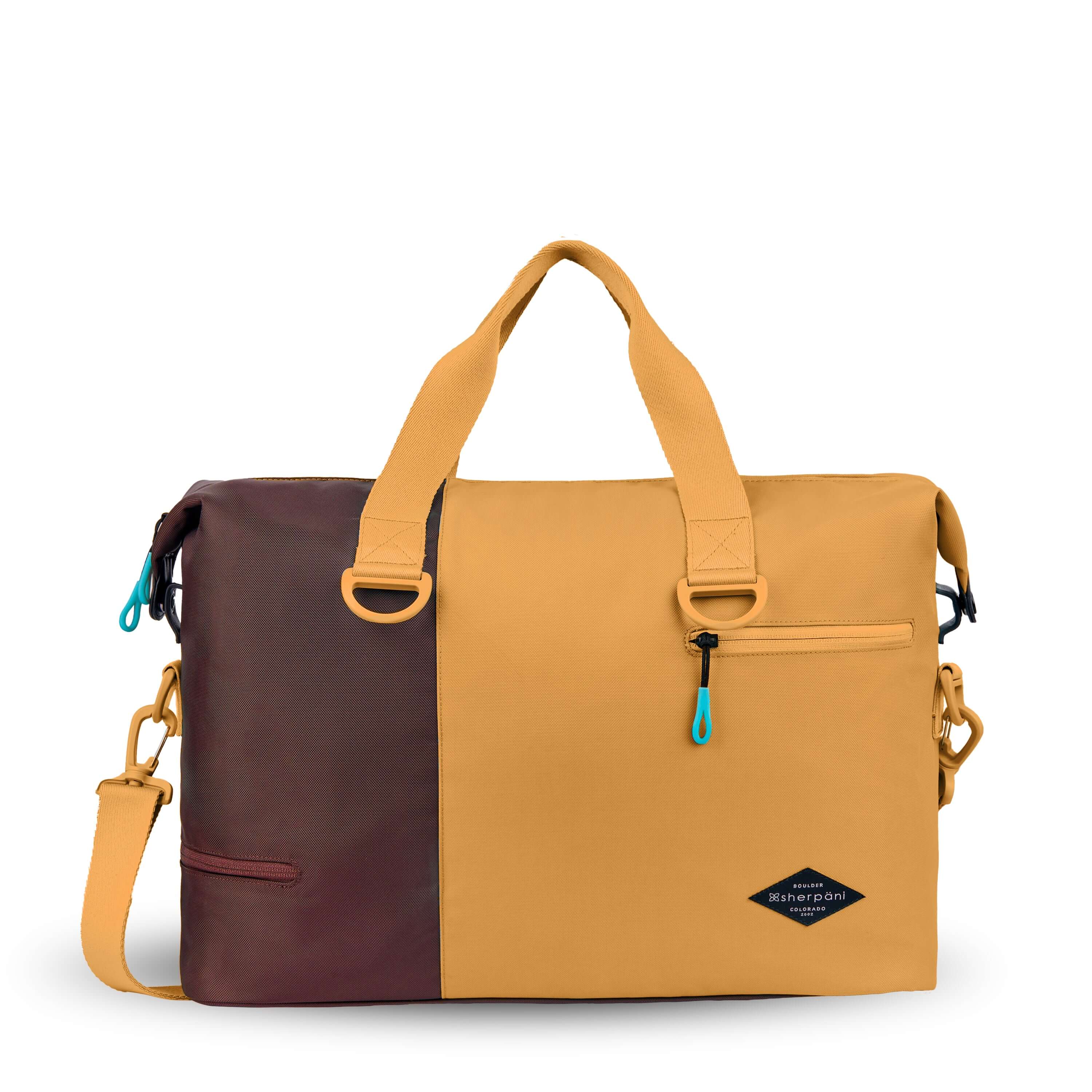 Flat front view of Sherpani bag, the Sola in Sundial. The bag is two-toned in burnt yellow and brown. Two external zipper compartments are visible on the top right and bottom left of the bag. Easy-pull zippers are accented in aqua. The bag has tote handles and an adjustable/detachable crossbody strap.
