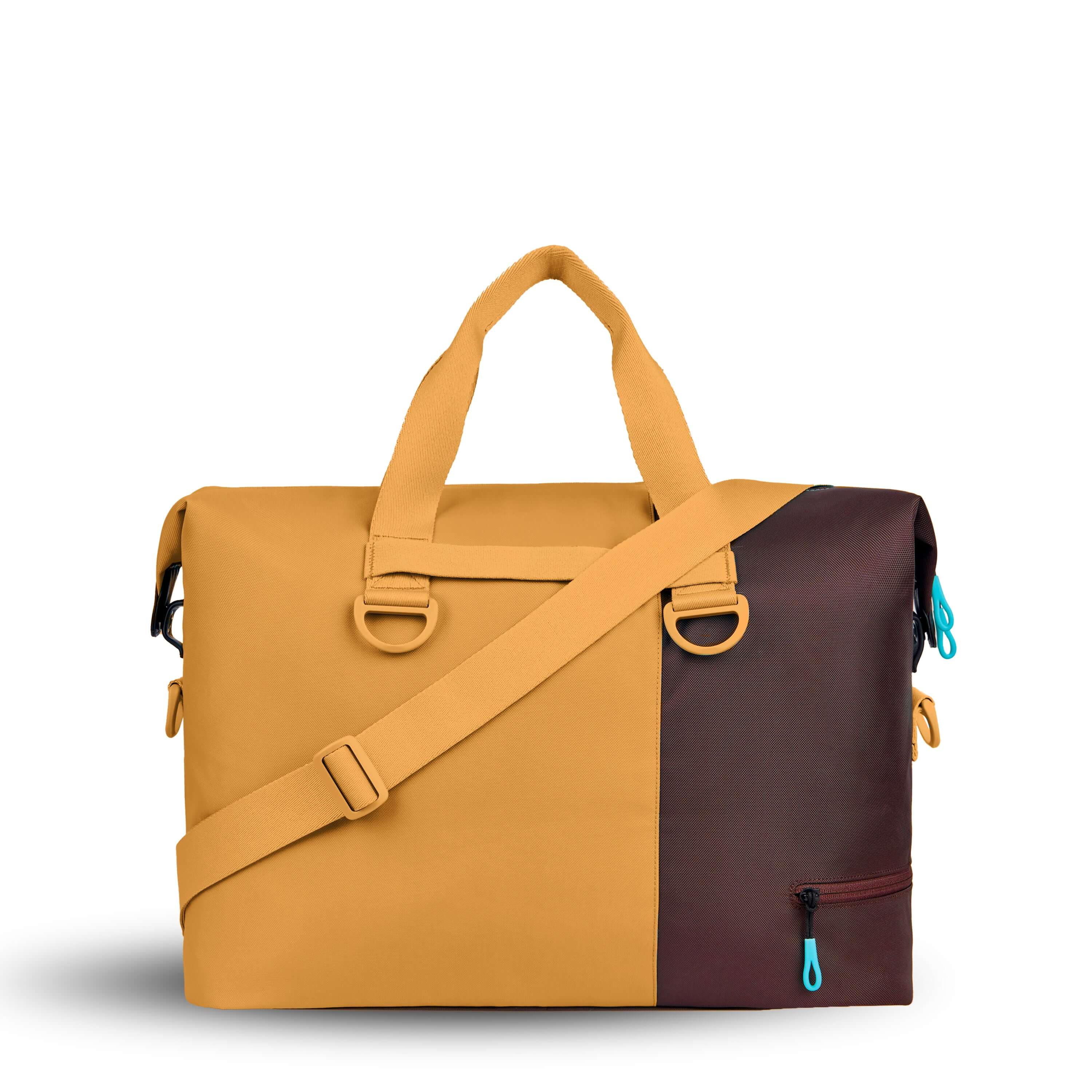 Back view of Sherpani bag, the Sola in Sundial. The bag is two-toned in burnt yellow and brown. Easy-pull zippers are accented in aqua. The bag has tote handles and an adjustable/detachable crossbody strap.
