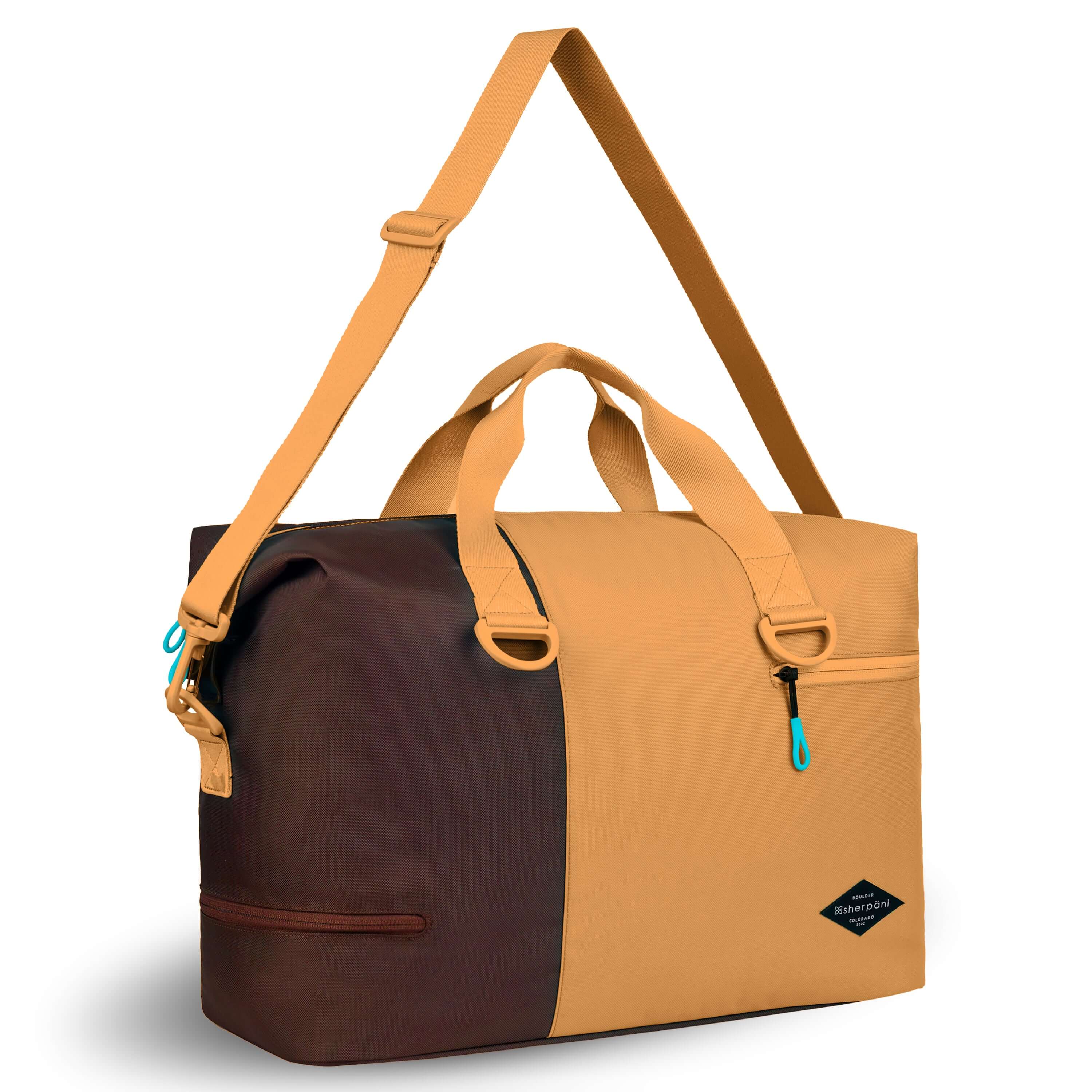 Angled front view of Sherpani bag, the Sola in Sundial. The bag is two-toned in burnt yellow and brown. Two external zipper compartments are visible on the top right and bottom left of the bag. Easy-pull zippers are accented in aqua. The bag has tote handles and an adjustable/detachable crossbody strap. 