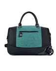 Flat front view of Sherpani’s Anti Theft rolling Duffle, the Trip in Teal, with vegan leather accents in black.  The bag lies flat on the ground with a retractable luggage handle hidden on the left side and the rolling wheels shown on the right side. The bag features short tote handles at the top and an external zipper compartment on the front panel with locking zipper and ReturnMe tag.