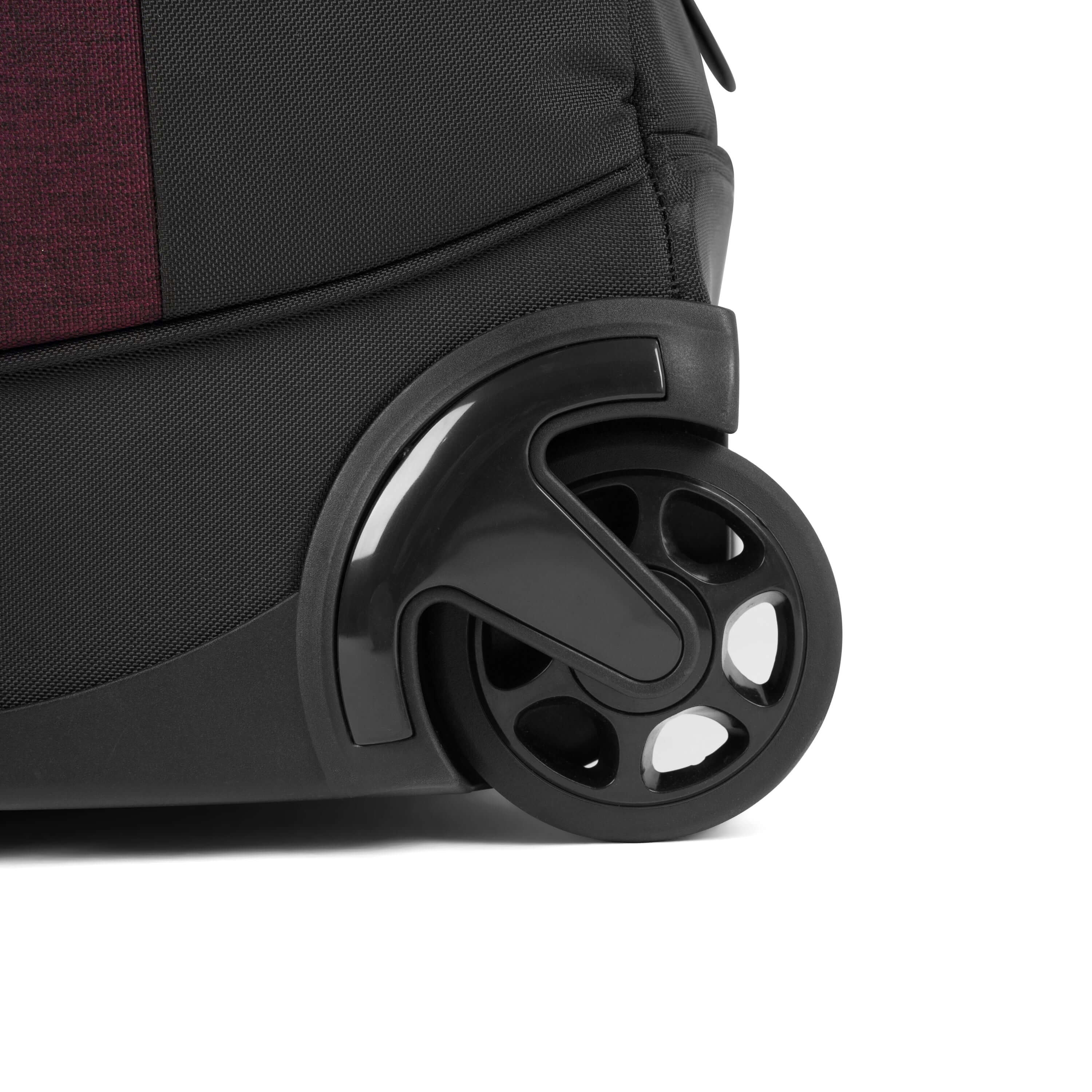 Close up view of rolling luggage wheels on Sherpani&#39;s Anti-Theft rolling duffle the Trip in Merlot.