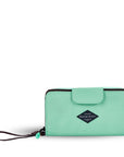 Flat front view of Sherpani wallet, the Tulum in Seagreen. The wallet is light green in color. There is a fabric flap with snap feature that folds over to open and close the wallet. There is a zipper compartment in the back with an easy-pull zipper accented in light green. The wallet features a wristlet strap in brown.