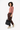 Model holding the Sherpani Vale AT in Carbon by the shoulder strap at her side #color_carbon