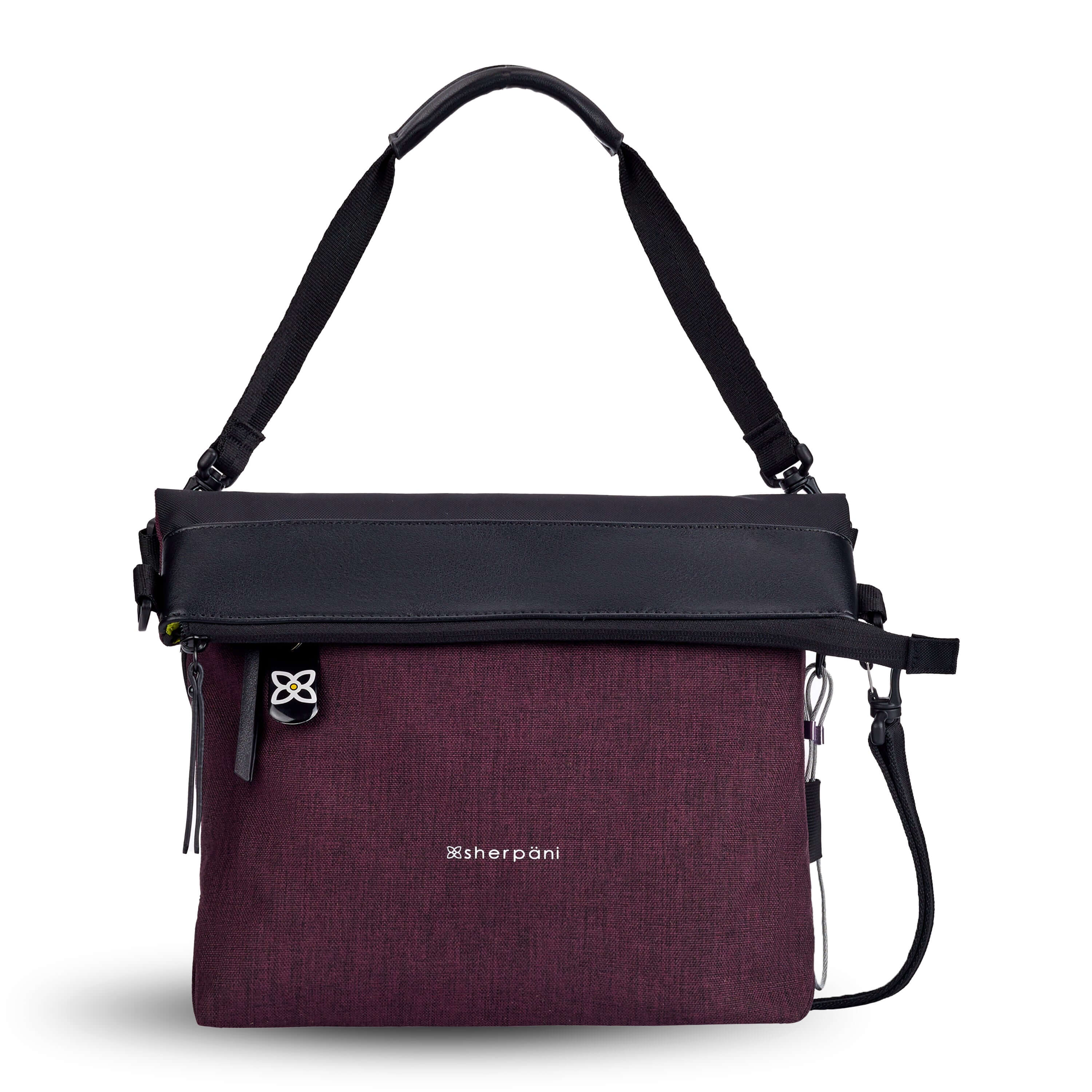 Flat front view of Sherpani&#39;s Anti-Theft bag, the Vale AT in Merlot with vegan leather accents in black. The top is folded over creating a two-toned reversible overlap. A chair loop lock is clipped onto one side, secured in place by an elastic tab. A ReturnMe tag is attached to the front zipper compartment. It has an adjustable/detachable crossbody strap, and a second detachable strap fixed at a shorter length.