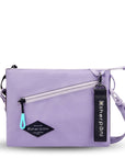Flat front view of Sherpani crossbody, the Zoom in Lavender. The bag is two-toned; the front half is lavender and the back half is brown. There is an external zipper pocket on the front with an easy-pull zipper accented in aqua. The bag has an adjustable/detachable crossbody strap. There is a branded Sherpani keychain clipped to a fabric loop on the upper right corner.