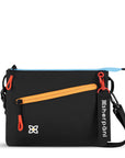 Flat front view of Sherpani small crossbody bag, the Zoom in Raven. Special features of the Zoom include RFID protection, adjustable crossbody strap, removable strap, removable keychain, outside zipper pocket, internal divider, internal zipper pockets and back slip pocket. The Chromatic color is black with pops of color in yellow, blue and red.