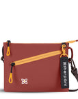Flat front view of Sherpani small crossbody bag, the Zoom in Cider. Special features of the Zoom include RFID protection, adjustable crossbody strap, removable strap, removable keychain, outside zipper pocket, internal divider, internal zipper pockets and back slip pocket. The Cider color is two-toned in dark brown and burgundy with yellow accents.