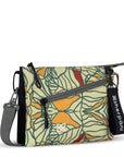 Angled front view of Sherpani small crossbody bag, the Zoom in Fiori. Special features of the Zoom include RFID protection, adjustable crossbody strap, removable strap, removable keychain, outside zipper pocket, internal divider, internal zipper pockets and back slip pocket. The Fiori colorway is two-toned in black and a floral pattern with a neutral color palette.