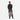 A man holding a Sherpani Crew Raven Black Travel Backpack by handheld strap against a white background. #color_dune-tan