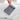 A woman holding a Sherpani Porter Passport Credit Card Sleeve Wallet against a white background.  #color_passport-print